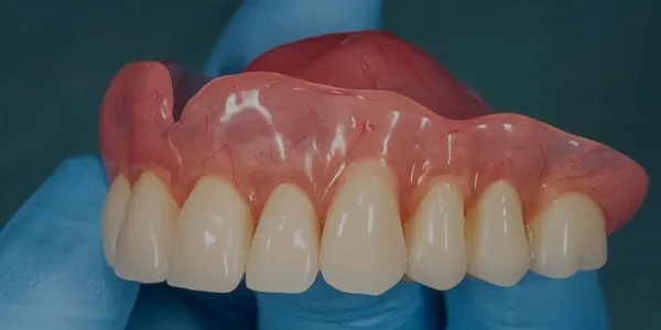 Dentures in a dark, low-contrast setting.