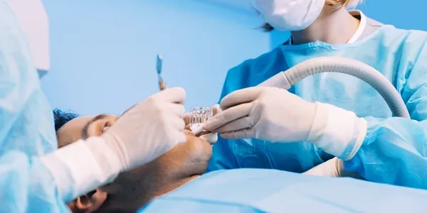 Tooth extraction procedure in a bright, low-contrast setting.